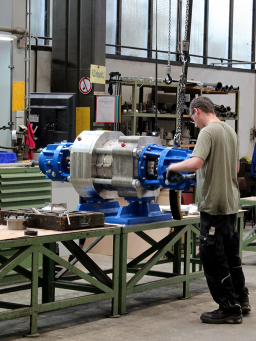 Mitarbeiter montiert eine horizontalen Gliederpumpe am Montagearbeitsplatz in der Fertigung.